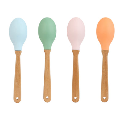 Four colorful spoons with wooden handles on a white background